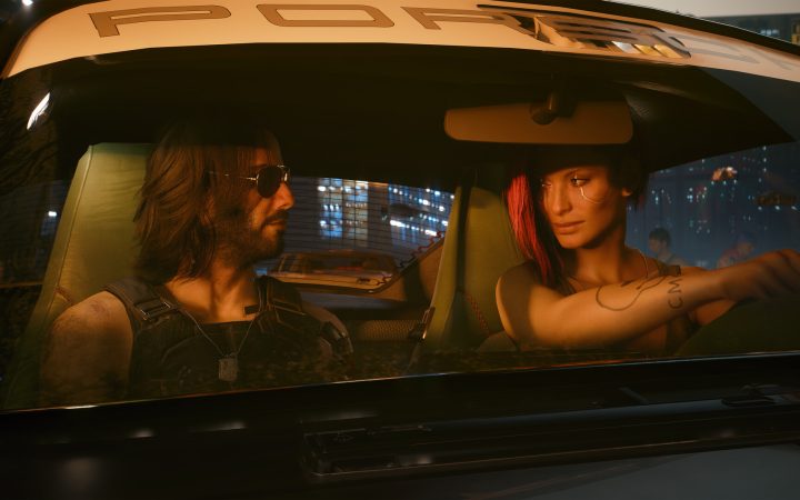 Johnny Silverhand and V ride in a Porsche through neon-lit Night City in Cyberpunk 2077