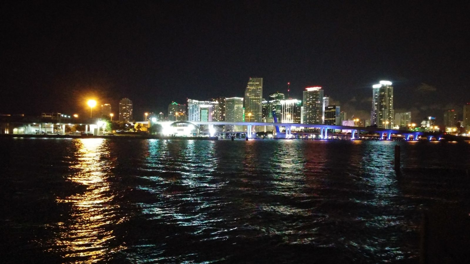 Downtown Miami skyline lit up at night over Biscayne Bay