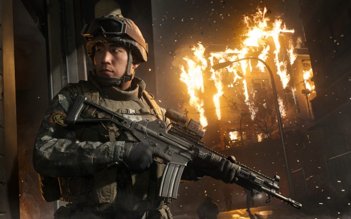 A soldier in tactical gear holds a rifle in front of a burning building in Call of Duty: Modern Warfare 4