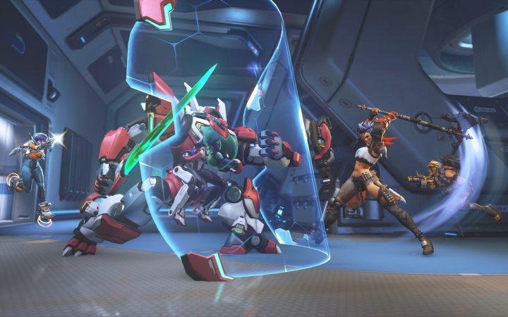 Overwatch heroes clash in a futuristic hangar as a barrier shield deflects fire